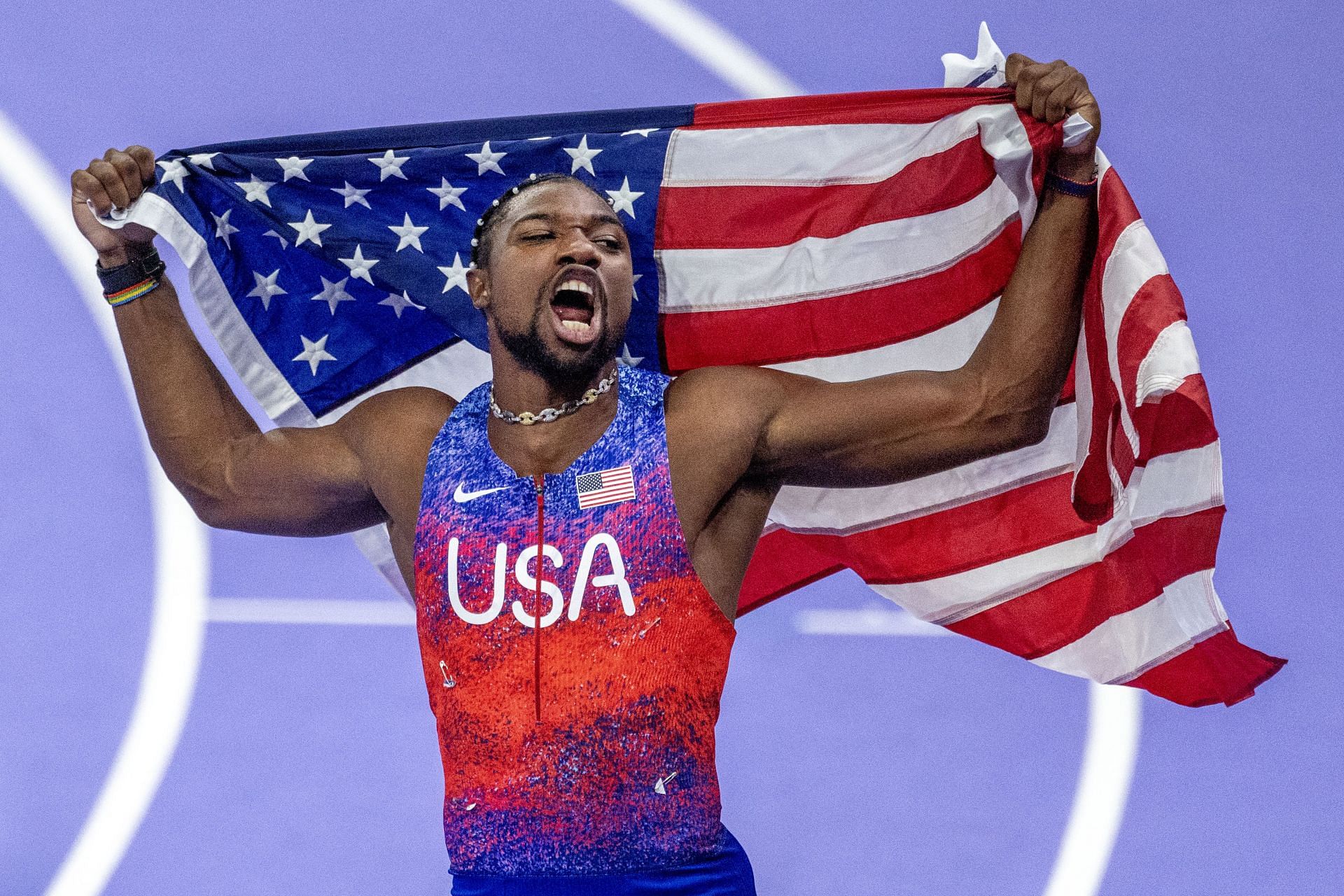 Lyles with the US flag at the Olympic Games-Paris 2024 - (Source: Getty)
